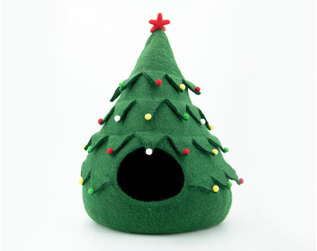 Green felt Christmas tree-shaped pet bed with decorative lights on a white background