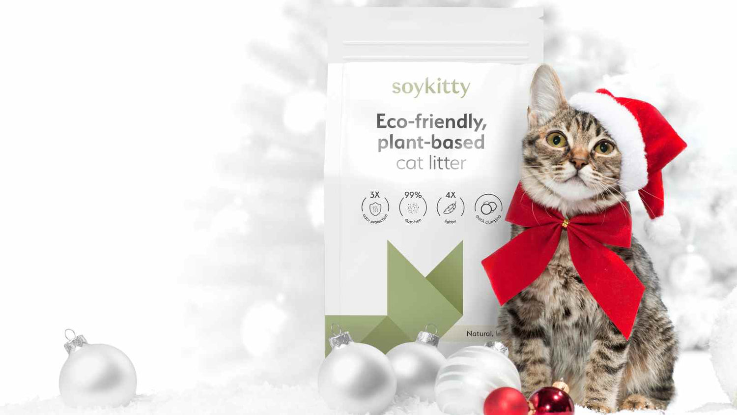 A festive holiday image featuring a curious tabby cat wearing a red Santa hat and bow, sitting next to a bag of SoyKitty eco-friendly, plant-based cat litter. Surrounded by Christmas ornaments, this image highlights the holiday spirit while promoting a healthier, dust-free environment for your cat with SoyKitty’s natural litter.